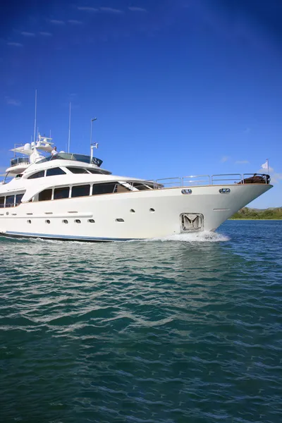 A yacht on calm waters with blue skies