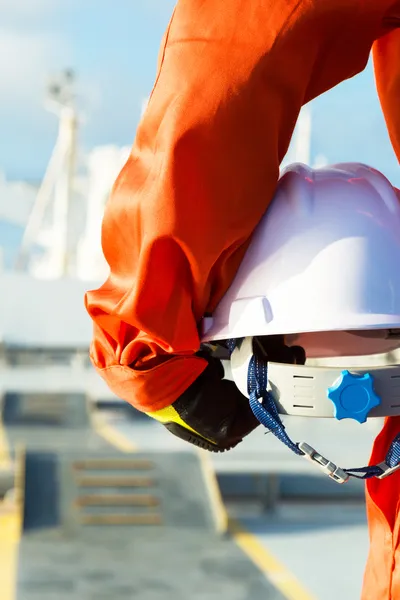Seafarer holding a helmet