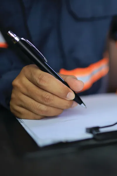 Seafarer writing on clipboard