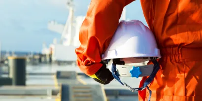 Seafarer holding a helmet