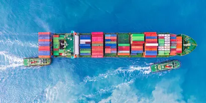 Cargo ship with two tug boats