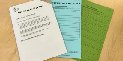 Three logbooks on a table