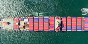 Container ship with tug boat