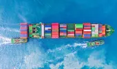 Cargo ship with two tug boats