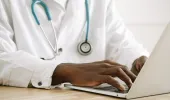 Doctor typing on laptop