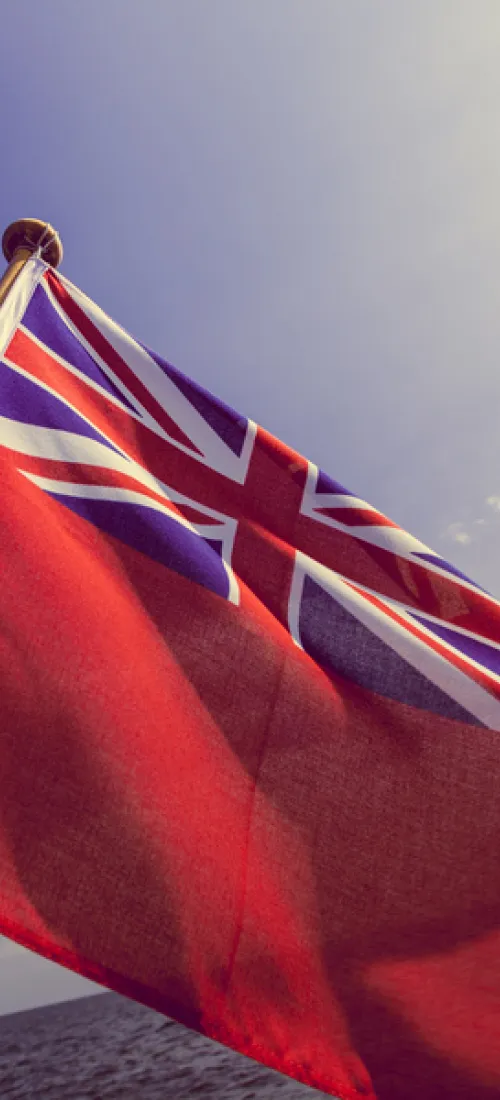 Red ensign flag against a blue sky